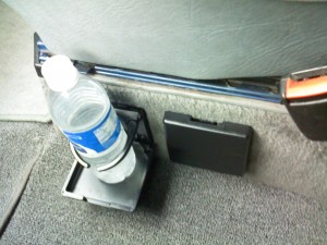 Below the passenger's seat