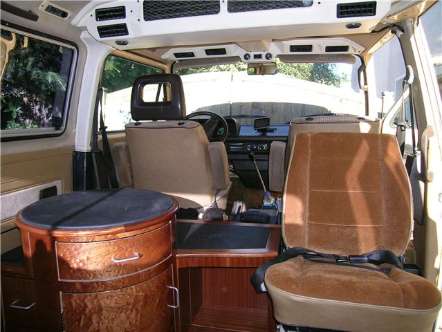 Custom Vanagon interior includes round table with drawers 